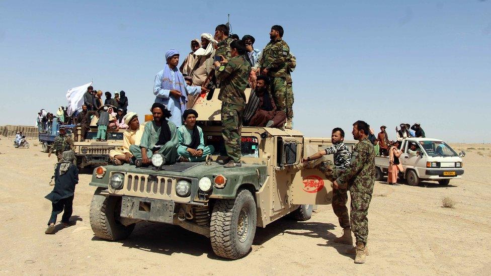 A group of Taliban militant poses with Afghan Army soldiers amid a three-day ceasefire during Eid celebrations, in Kandahar, Afghanistan, 17 June 2018