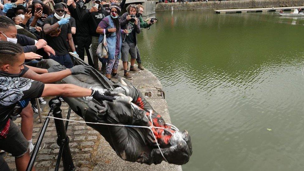 Colston statue lowered into Bristol harbour