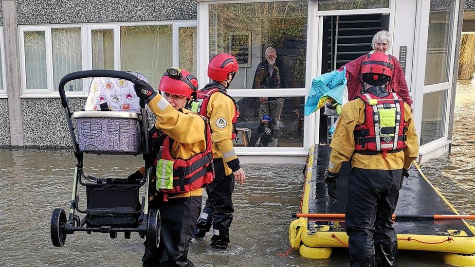 Firefighters rescuing families