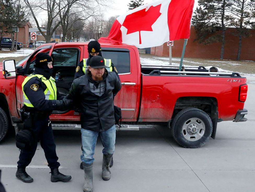 Police detain a protester