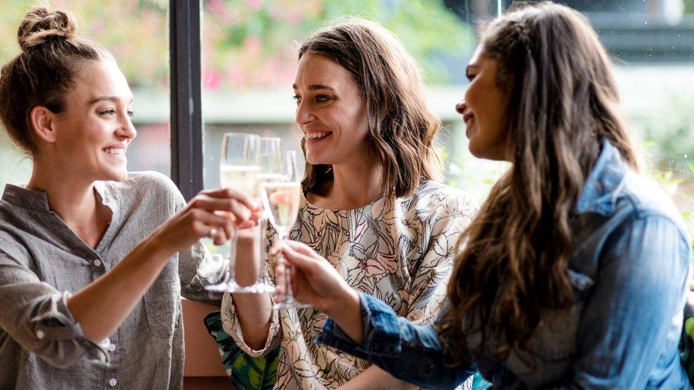 Three women drinking alcohol