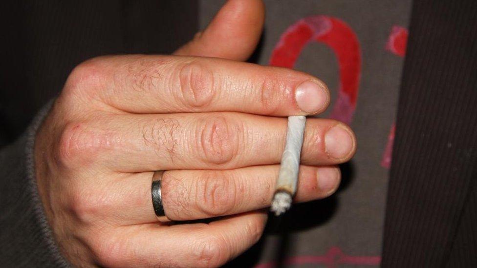 Stock shot of a man holding a spliff