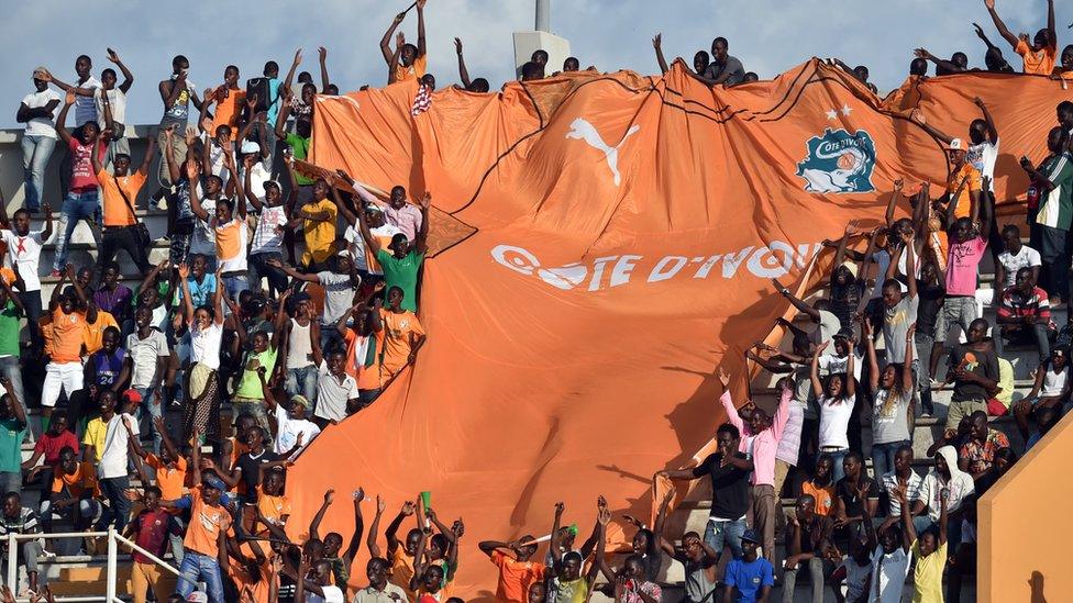 Ivory Coast"s national football team fans display a giant jersey during the 2017 African Cup of Nations qualification football match between Ivory Coast and Gabon at the Stade de la Paix on June 4, 2016 in Bouake. / AFP PHOTO / ISSOUF SANOGOISSOUF SANOGO/AFP/Getty Images