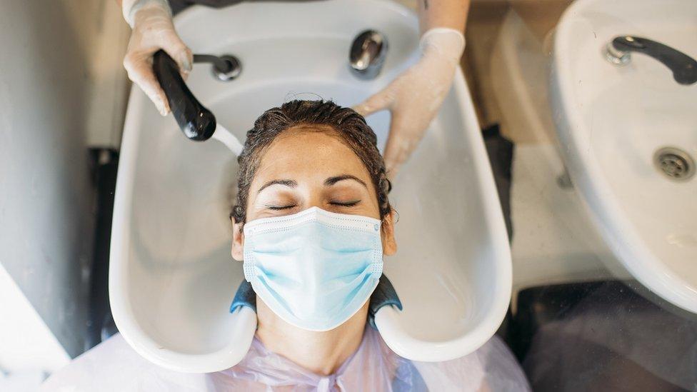 Woman having hair washed in hair salon