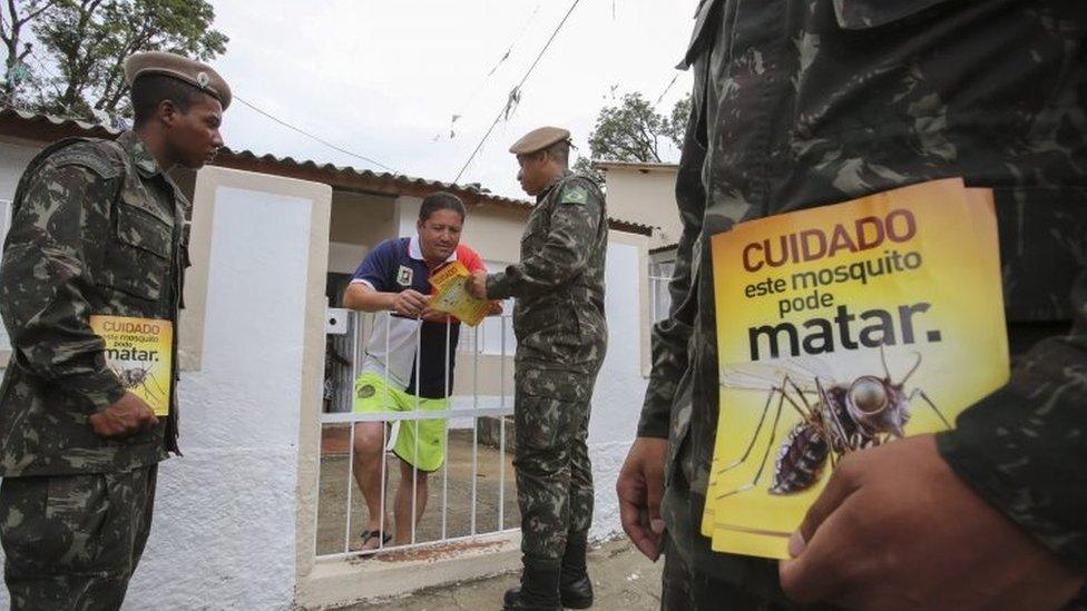 Brazilian soldiers give a resident in Sao Paulo leaflets that read: "This mosquito can be deadly". Photo: 29 January 2016