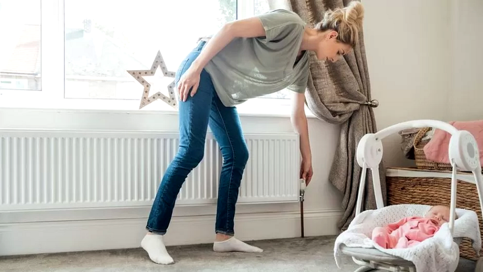 Woman checks radiator