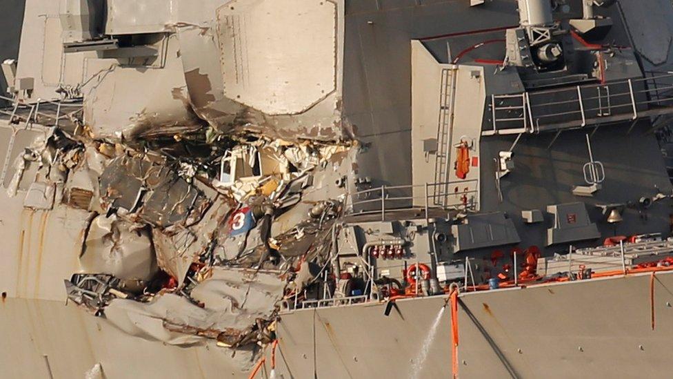 The Arleigh Burke-class guided-missile destroyer USS Fitzgerald, damaged by colliding with a Philippine-flagged merchant vessel, is towed into the U.S. naval base in Yokosuka