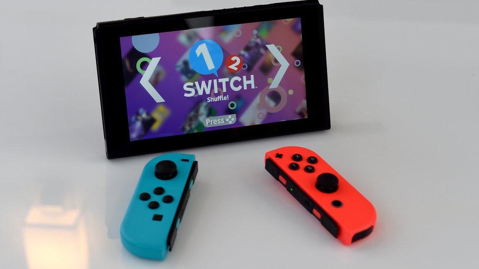 Nintendo Switch with Joy-con controllers removed, in portable mode, running 1-2 Switch game