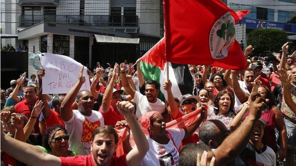 Supporters of Brazil"s former President Luiz Inacio Lula da Silva gather outside of his residence building, in Sao Bernardo do Campo, in the greater Sao Paulo area, Brazil, on Saturday, March 5, 2016.