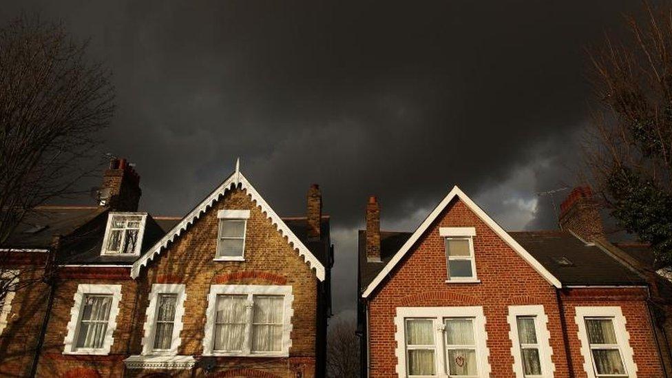 Dark clouds over houses