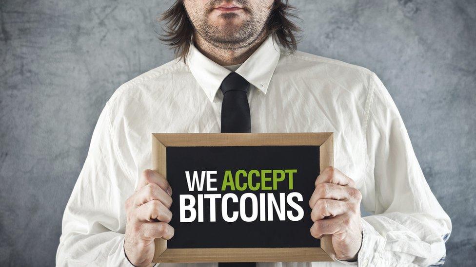 "we accept bitcoins" sign