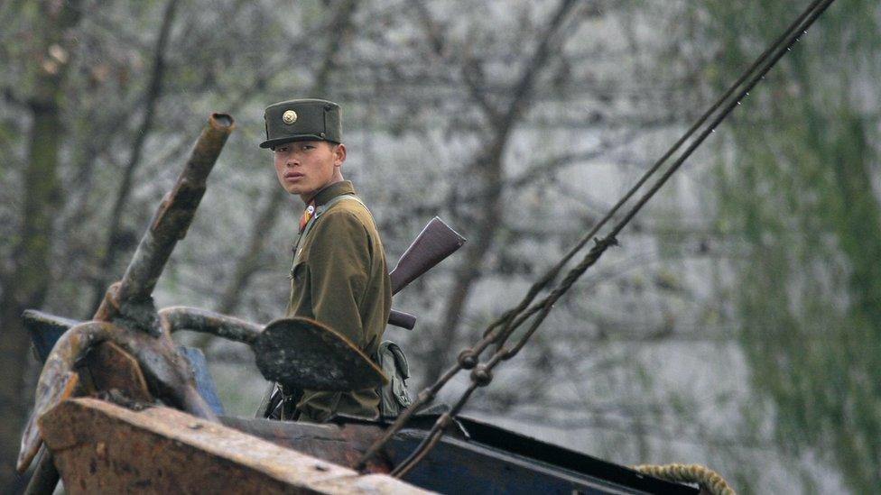 North Korean soldier beside the Yalu River, Sinuiju, near the border with China