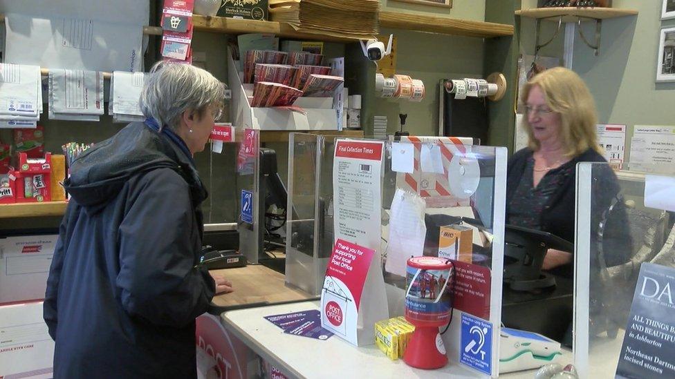 Sue Boulton serves a customers in Moretonhampstead's Post Office