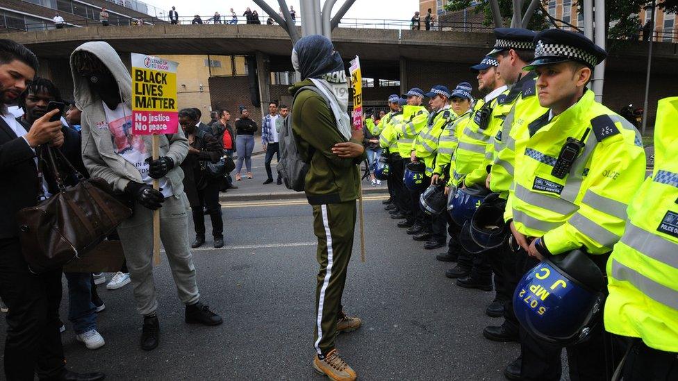 A Black Lives Matter protester in front of police