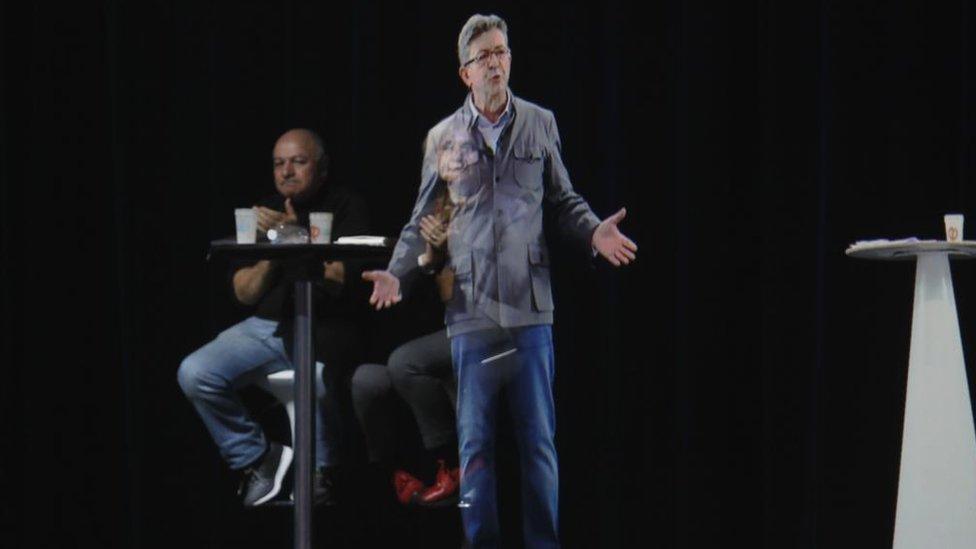 French presidential election candidate Jean-Luc Melenchon delivers a speech via hologram