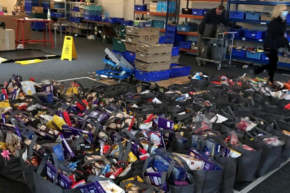 Dozens of bags of food in a foodbank