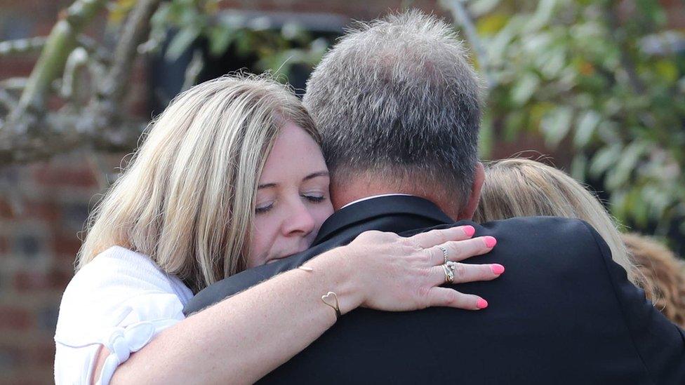 Pc Harper's mother hugs other family members