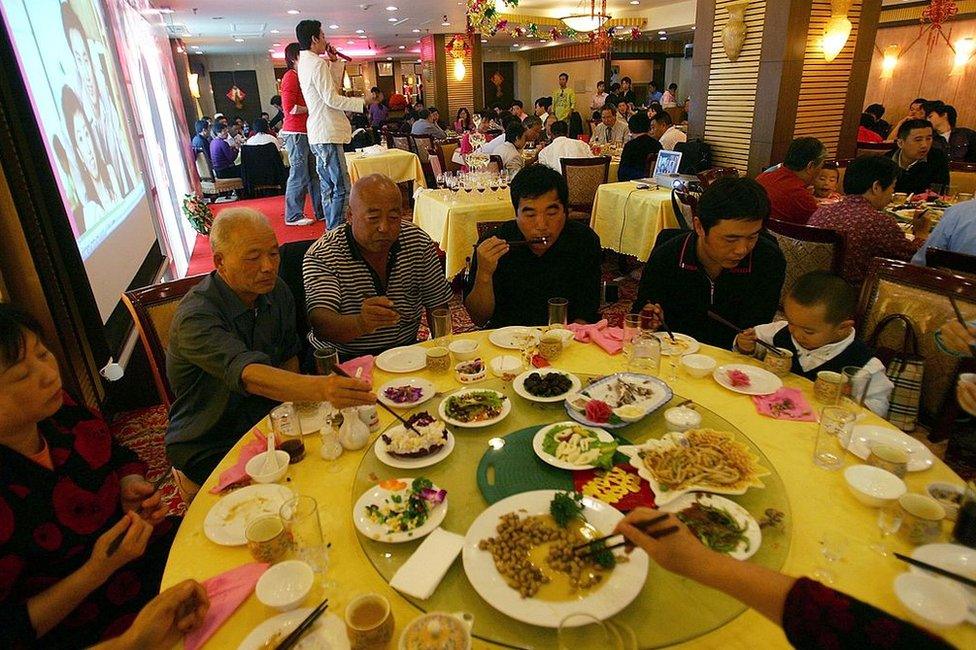 Guests have a five-course banquet at a hotel during a wedding ceremony on 9 September 2006 in Beijing, China.