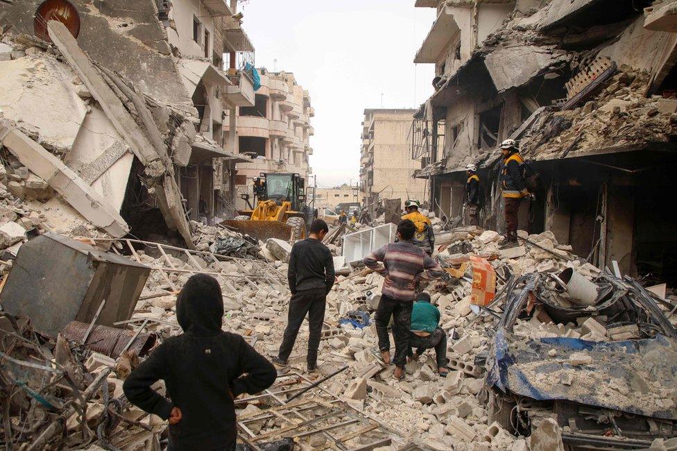 Rescue workers clear debris from the site of an air strike in Ariha, in Idlib province, Syria (30 January 2020)