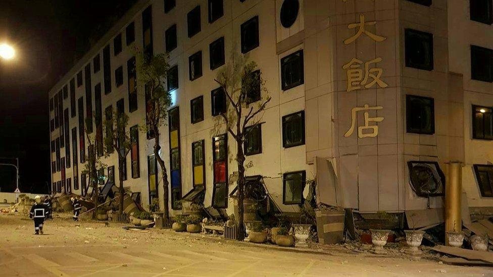 A hotel is pictured with its bottom floors crushed