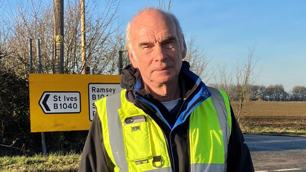 Man standing in front of road