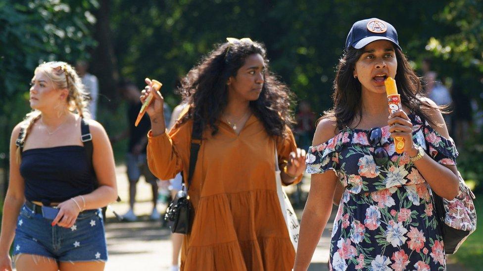 People in the sunshine in St James's Park, London