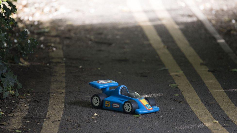 A toy car on its own in the road