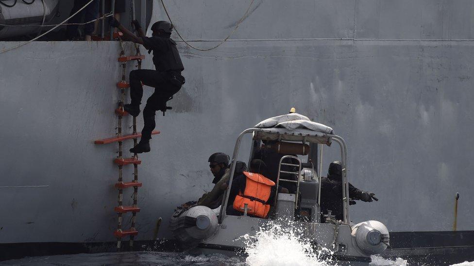 A Nigerian special forces officer climbs aboard a vessel during an anti-piracy exercise, March 2019