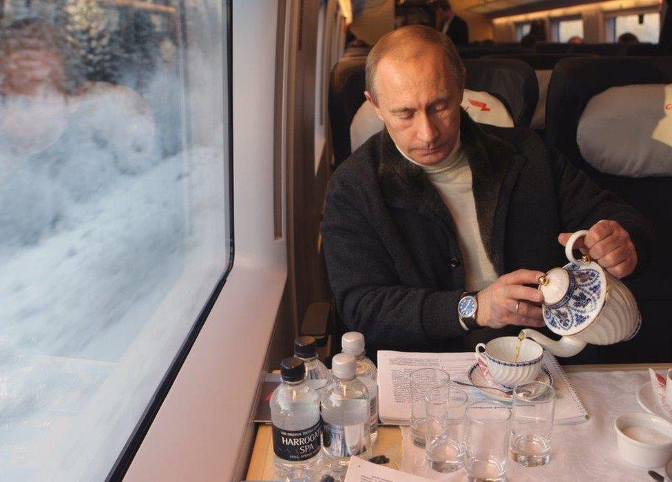 Vladimir Putin having tea on the Sapsan train to St Petersburg