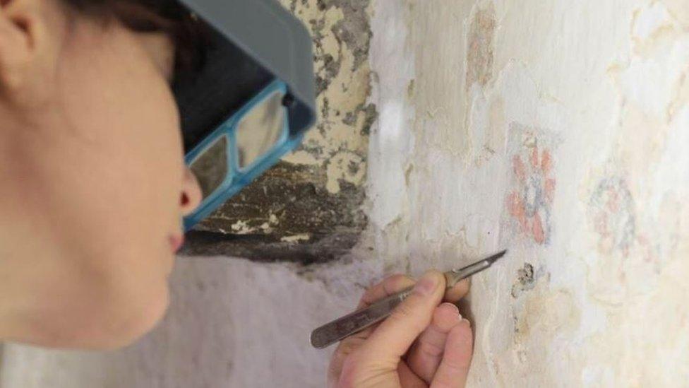 the conservation team works to remove layers of damaging materials such as plaster