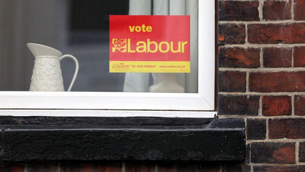 A window with a Vote Labour posted stuck to the glass