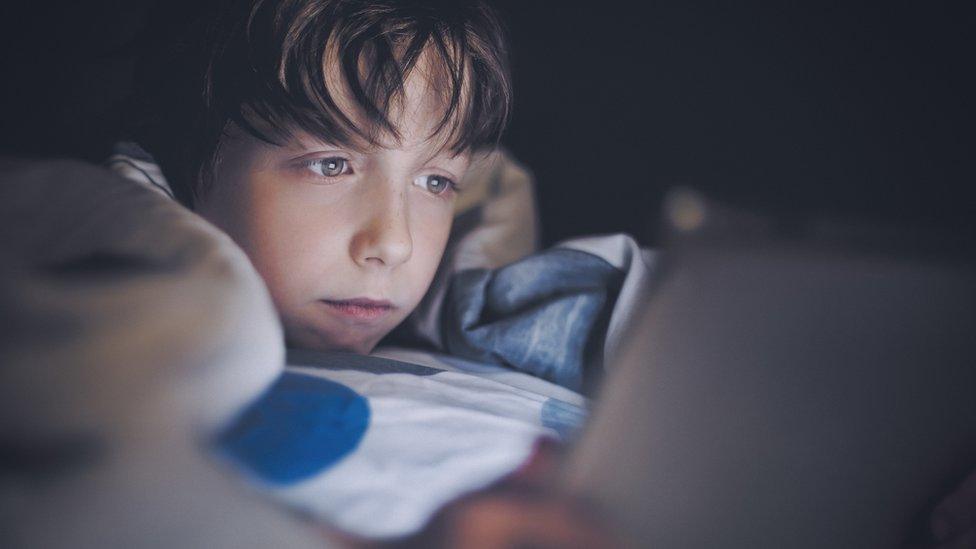 A child looking at a tablet