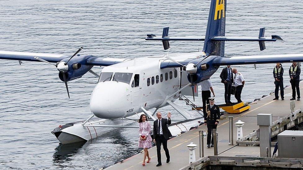 The duke and duchess stepping out of a Twin Otter aircraft