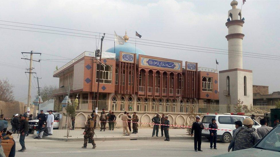 Afghan security forces keep watch in front of a mosque where an explosion happened in Kabul, Afghanistan