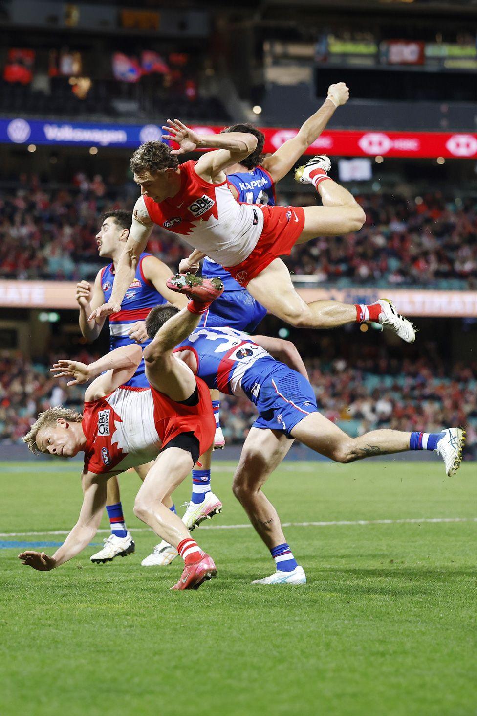 Will Hayward of the Swans flies over a pack attempting to mark the ball during the match against the Western Bulldogs in Sydney. Photo by Darrian Traynor