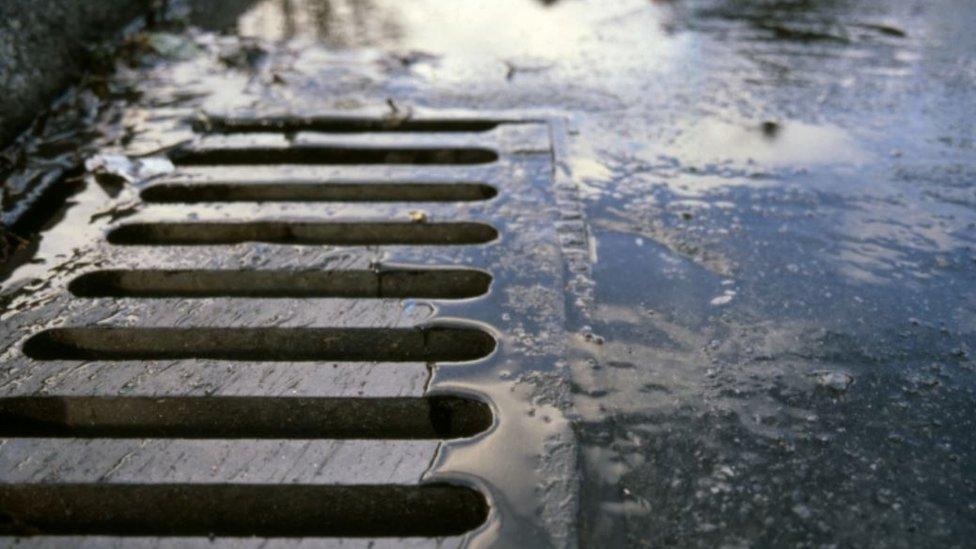 Rain on road with drain