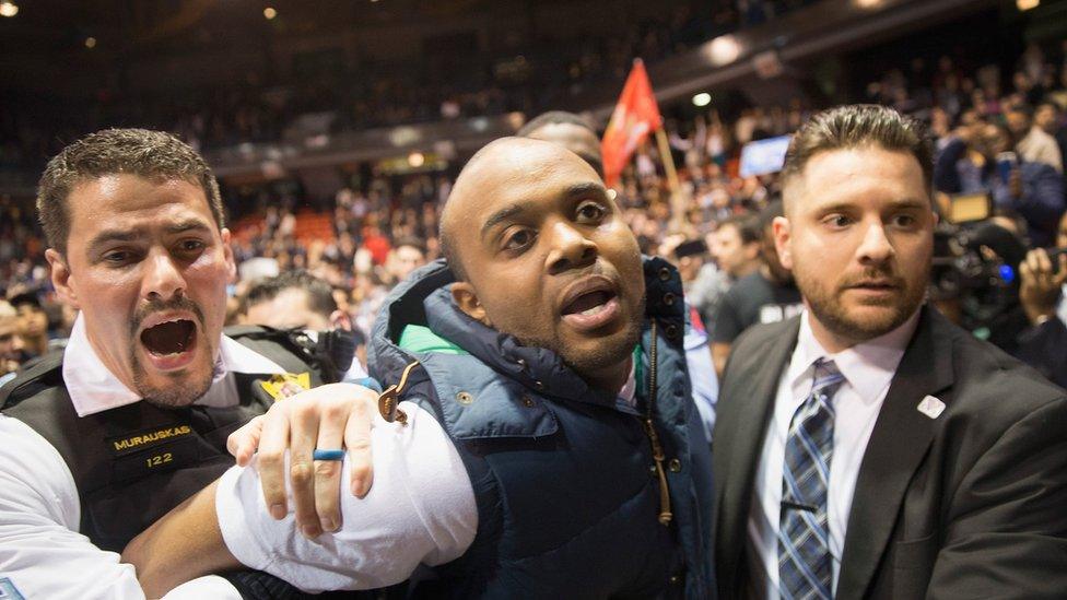 An activist is removed by police after it was announced that a rally with Republican presidential candidate Donald Trump at the University of Illinois at Chicago would be postponed on March 11, 2016 in Chicago, Illinois.