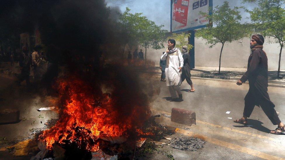 Afghan protesters set a fire during a protest in Kabul, Afghanistan 2 June 2017