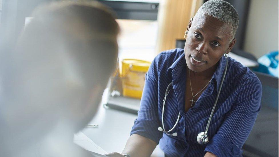 A doctor speaking to a patient