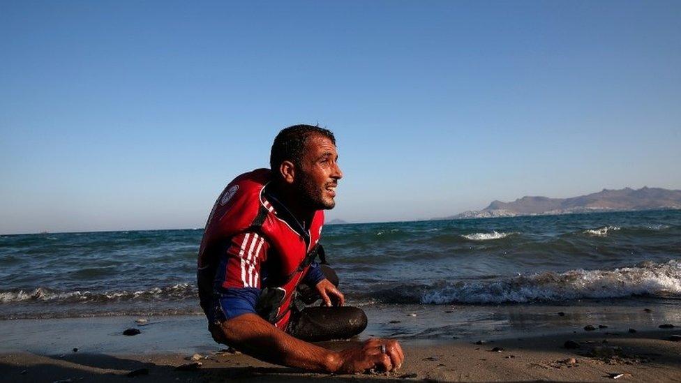 A migrant from Syria rests on the beach in Kos, Greece (29 Aug 2015)