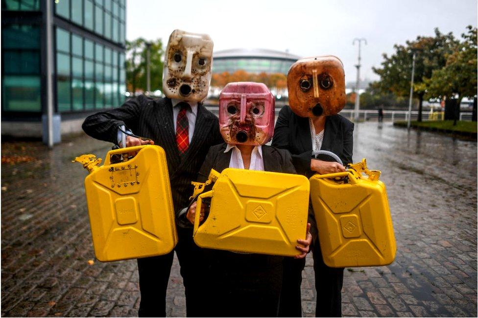 Activists from Ocean Rebellion wearing Oil participate in a protest outside the Hydro on October 29, 2021 in Glasgow, Scotland.