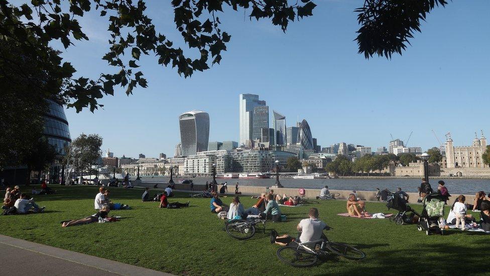 People enjoying the warm weather in Potters Fields Park