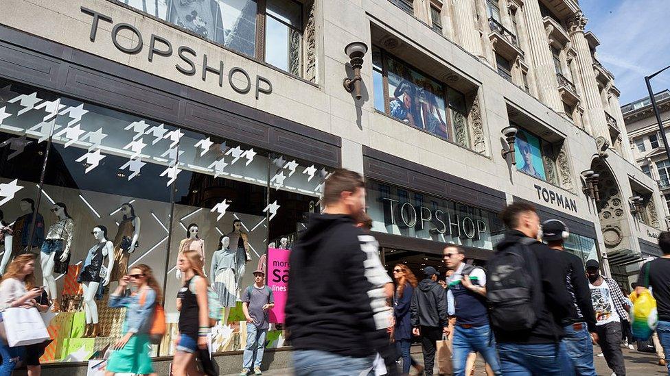 People walk past Topshop, Oxford Street