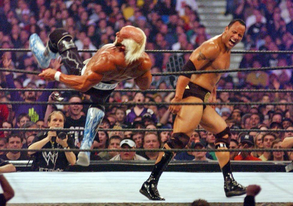 Hulk is falling backwards over the top rope as The Rock walks away with his ecpression in a triumphant scream at Wrestlemania X8 in 2002