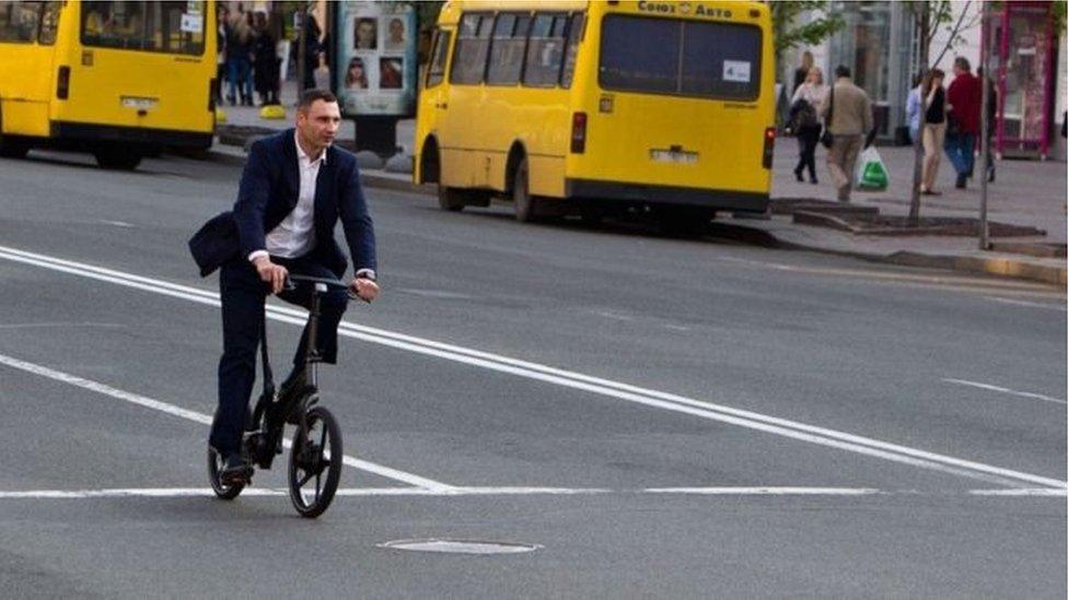 Vitaliy Klitschko's riding a bike.