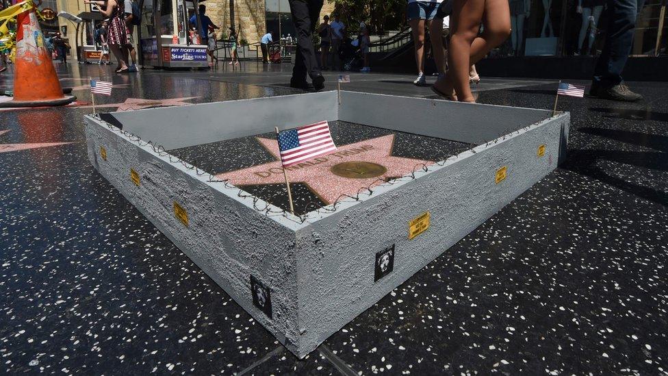 Miniature US flag on Plastic Jesus' wall