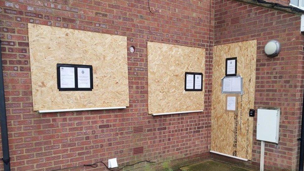 Brick-built house with boards over windows and doors