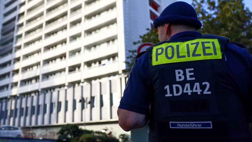 A police officer on guard during a raid against neo-Nazis in the east of Berlin