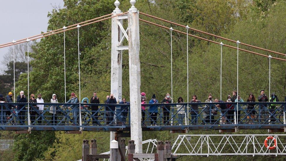 Onlookers crowded onto a bridge and the towpath at Teddington to look for the whale