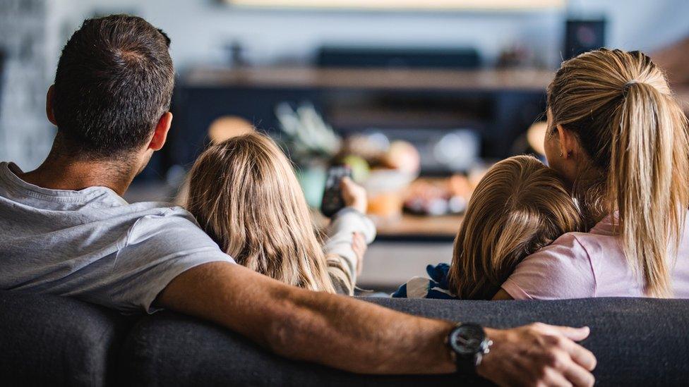 Family watching TV.